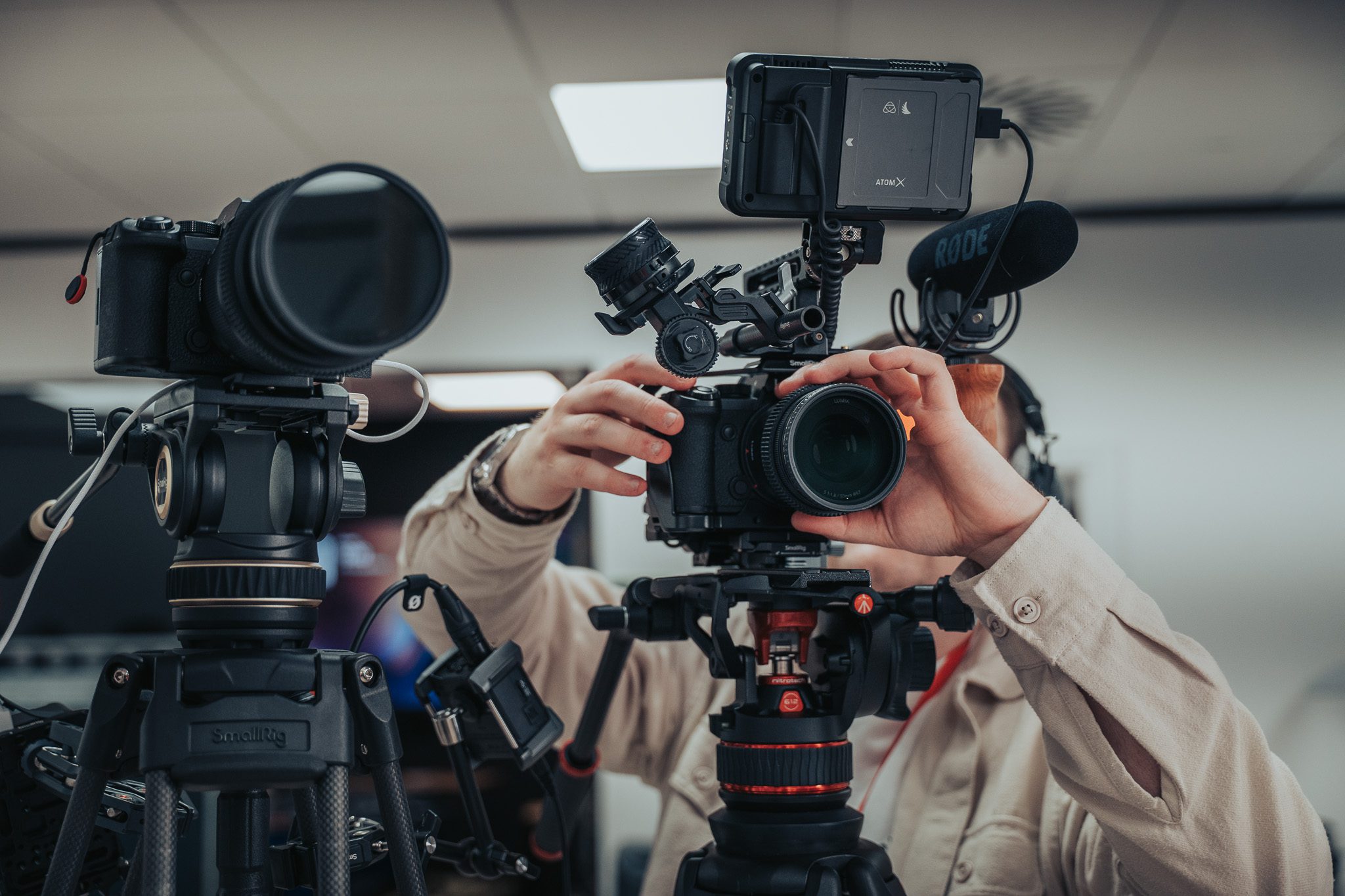 a camera operator setting focus on a two-camera interview