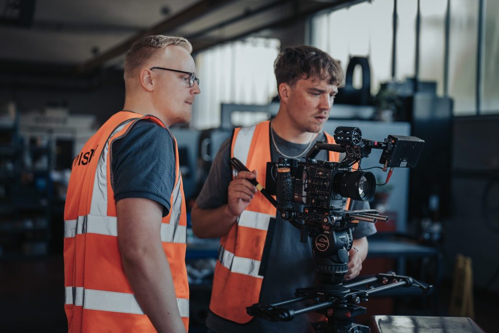 producer and camera operator filming in a warehouse