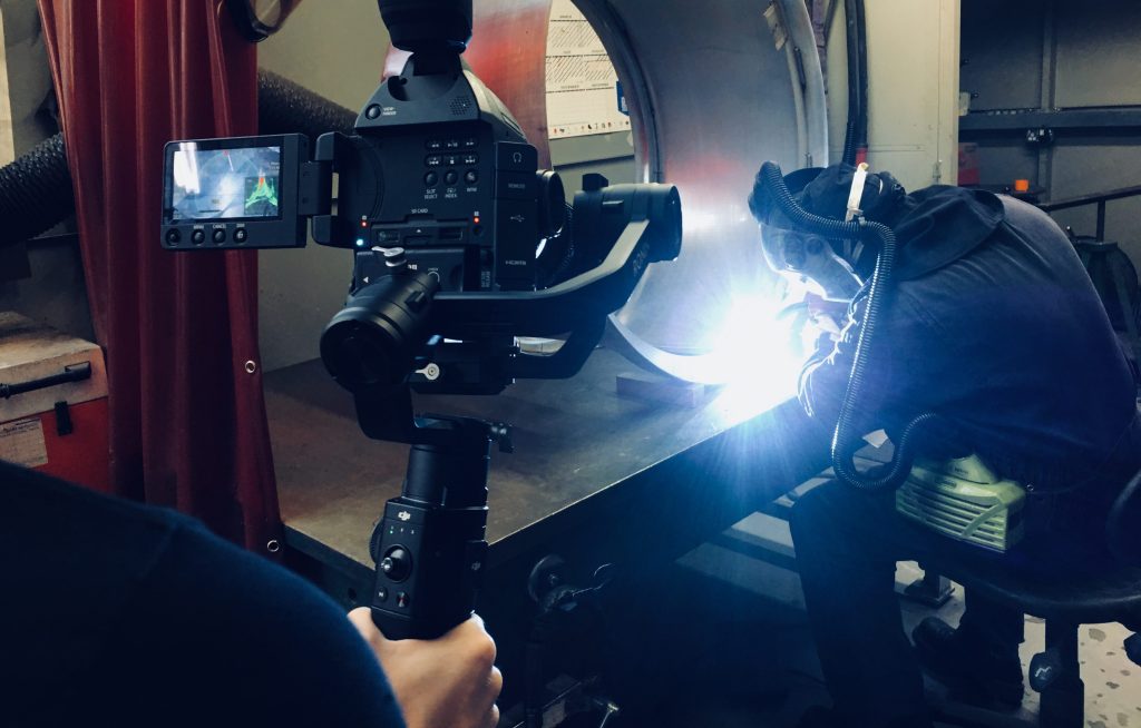 filming a video in an industrial warehouse